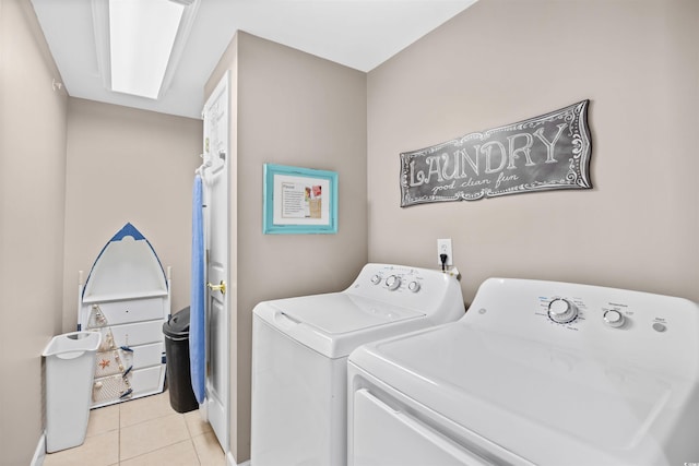 3401 N Ocean Blvd Unit 309, North Myrtle Beach, SC 29582 - clothes washing area with washing machine and clothes dryer, light tile patterned floors, and baseboards