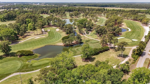 aerial overview of property's location featuring a nearby body of water, a golf club, and a tree filled landscape