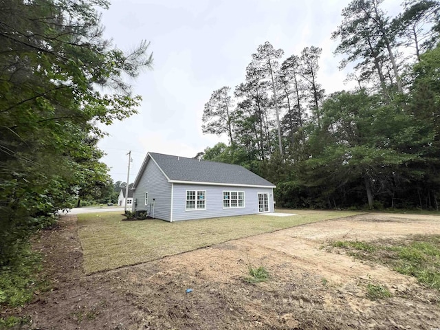 2593 Main St, Loris, SC 29569 - view of home's exterior with a yard and a shingled roof