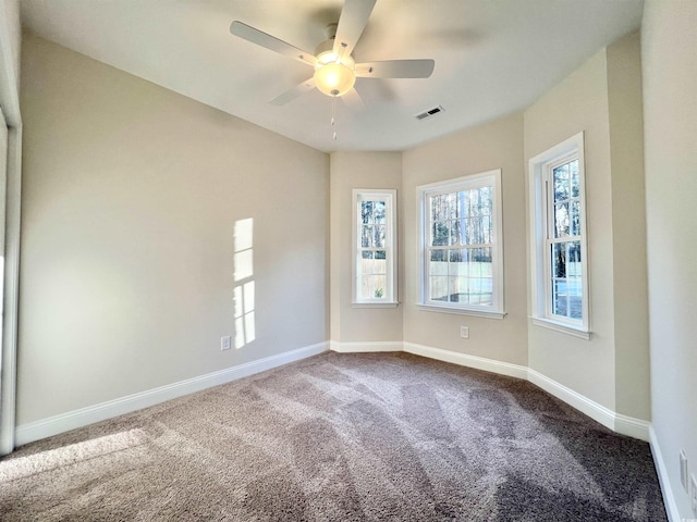 2593 Main St, Loris, SC 29569 - empty room with dark colored carpet, baseboards, and ceiling fan