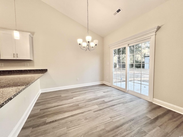 2593 Main St, Loris, SC 29569 - unfurnished dining area with wood finished floors, a chandelier, baseboards, and high vaulted ceiling