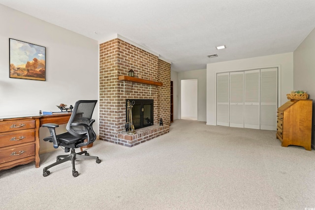office area featuring light carpet and a fireplace