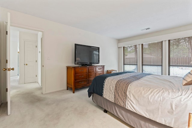 bedroom with light carpet and baseboards