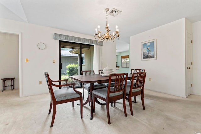dining space featuring light colored carpet, a chandelier, and plenty of natural light