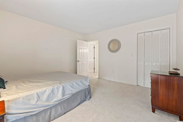 bedroom featuring light carpet and a closet