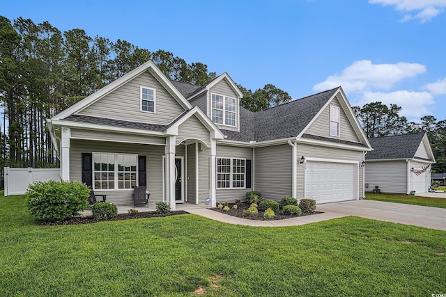 630 Heartwood Dr, Conway, SC 29526 - traditional-style house featuring roof with shingles, concrete driveway, a garage, and covered porch