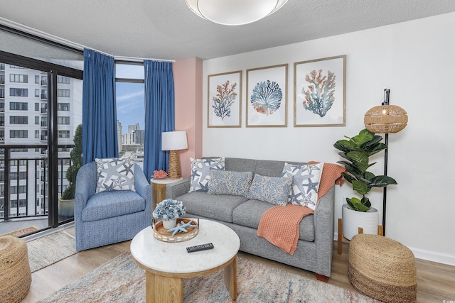 1501 S Ocean Blvd Unit 1250, Myrtle Beach, SC 29577 - living room featuring wood finished floors, floor to ceiling windows, a textured ceiling, and baseboards