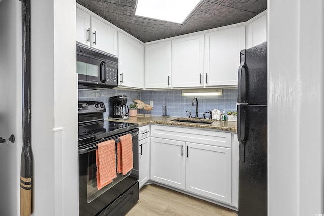 1501 S Ocean Blvd Unit 1250, Myrtle Beach, SC 29577 - kitchen with black appliances, a sink, tasteful backsplash, light stone countertops, and white cabinets
