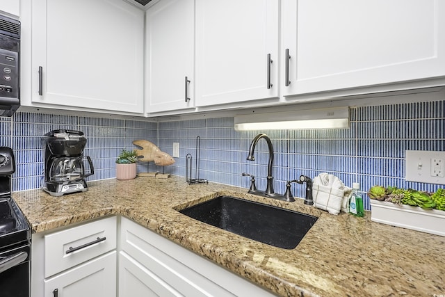 1501 S Ocean Blvd Unit 1250, Myrtle Beach, SC 29577 - kitchen featuring a sink, white cabinetry, and decorative backsplash