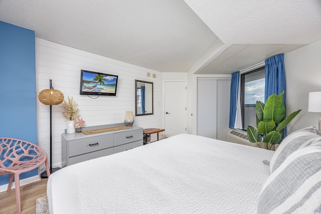 1501 S Ocean Blvd Unit 1250, Myrtle Beach, SC 29577 - bedroom with wood finished floors, a closet, and wood walls