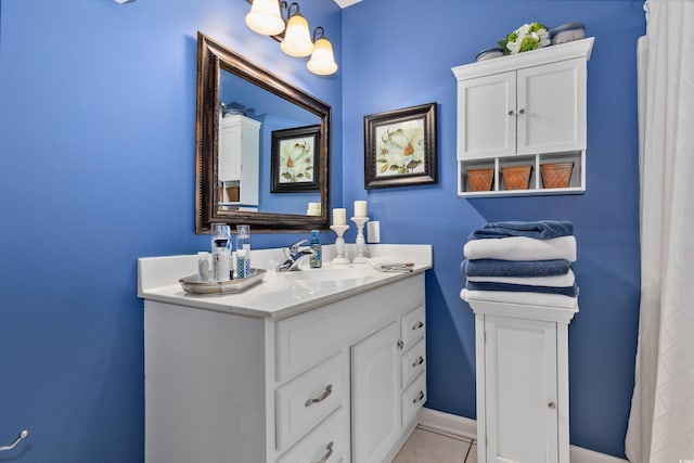 bathroom with vanity, tile patterned floors, and baseboards