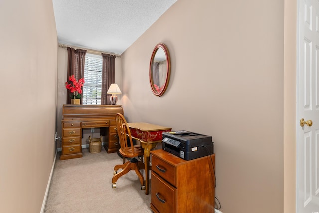 office space with carpet, baseboards, and a textured ceiling
