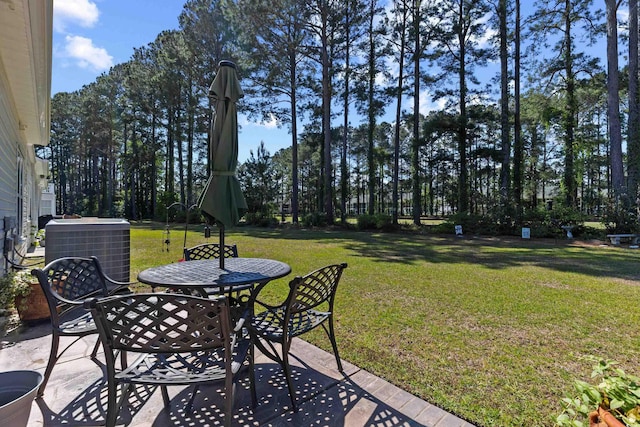 view of patio with central AC and outdoor dining area