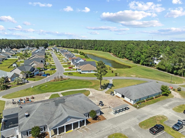 aerial view of residential area featuring a nearby body of water and a local golf course