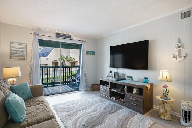 6000 N Ocean Blvd Unit 133, North Myrtle Beach, SC 29582 - living room featuring wood finished floors, ornamental molding, a textured ceiling, and baseboards