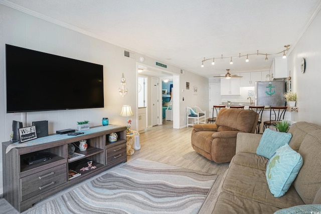 6000 N Ocean Blvd Unit 133, North Myrtle Beach, SC 29582 - living area with light wood-style floors, ornamental molding, and a ceiling fan