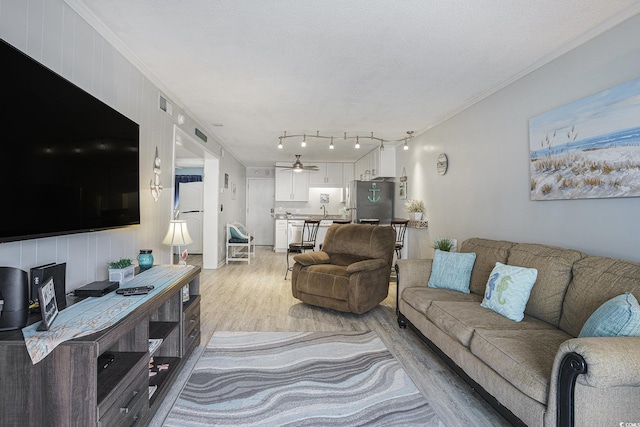 6000 N Ocean Blvd Unit 133, North Myrtle Beach, SC 29582 - living area with light wood-type flooring, ceiling fan, and crown molding