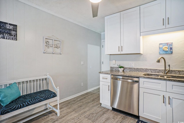 6000 N Ocean Blvd Unit 133, North Myrtle Beach, SC 29582 - kitchen featuring stainless steel dishwasher, a sink, stone countertops, crown molding, and light wood-type flooring