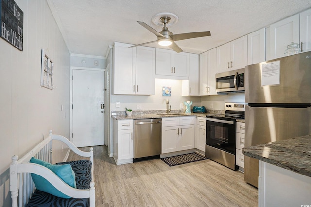 6000 N Ocean Blvd Unit 133, North Myrtle Beach, SC 29582 - kitchen featuring stainless steel appliances, a sink, light wood-style floors, a ceiling fan, and white cabinets