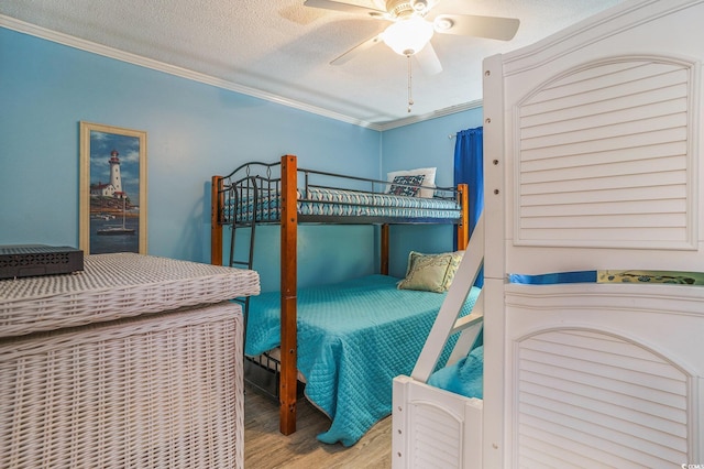 6000 N Ocean Blvd Unit 133, North Myrtle Beach, SC 29582 - bedroom featuring wood finished floors, ornamental molding, ceiling fan, and a textured ceiling