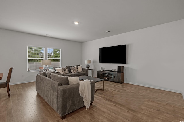 living room with wood finished floors and baseboards