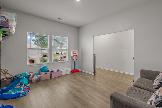recreation room with wood finished floors and baseboards