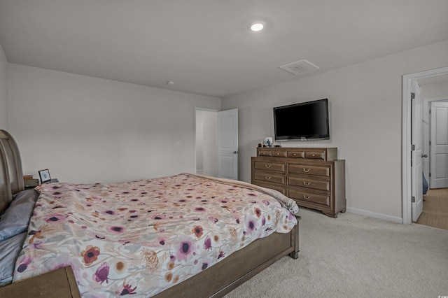 bedroom featuring light carpet and baseboards