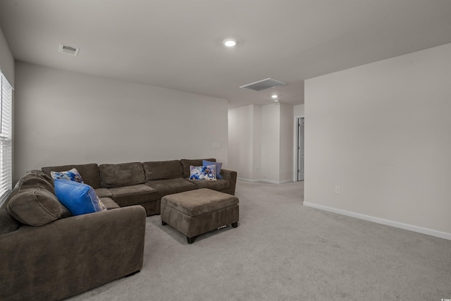 living room featuring light carpet, baseboards, and recessed lighting