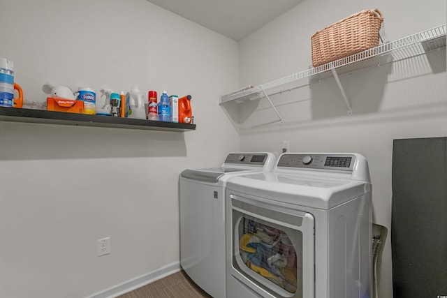 laundry area featuring washer and dryer and baseboards