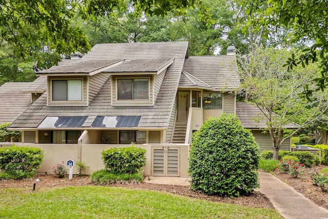 400 Melrose Pl Unit 14E, Myrtle Beach, SC 29572 - view of front facade featuring a fenced front yard and a chimney