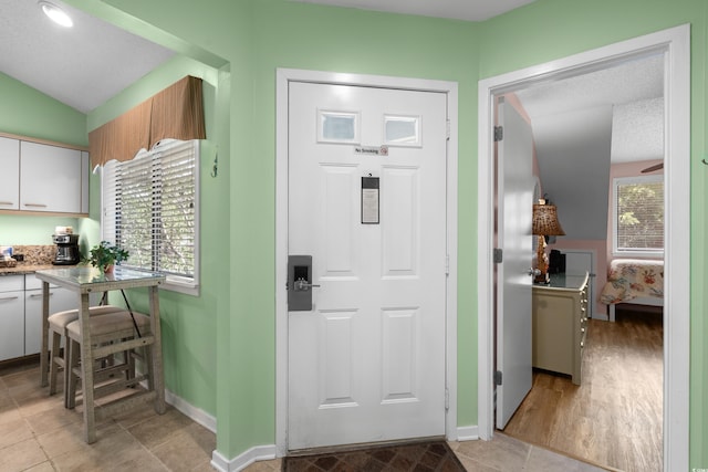400 Melrose Pl Unit 14E, Myrtle Beach, SC 29572 - entryway featuring baseboards and vaulted ceiling