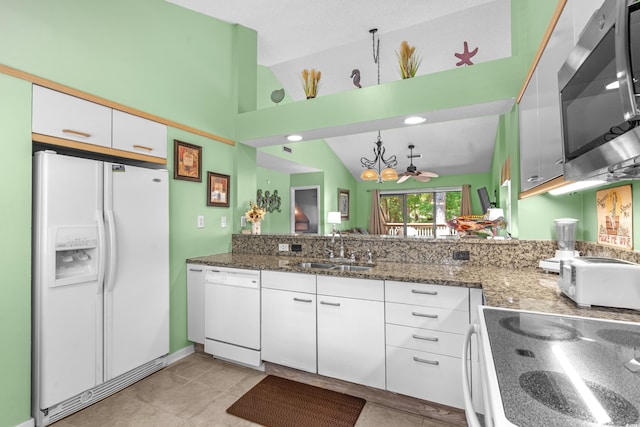 400 Melrose Pl Unit 14E, Myrtle Beach, SC 29572 - kitchen with white appliances, a sink, vaulted ceiling, white cabinets, and a chandelier