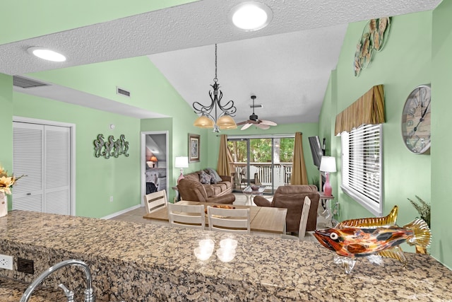 400 Melrose Pl Unit 14E, Myrtle Beach, SC 29572 - living area featuring vaulted ceiling, a fireplace, a textured ceiling, tile patterned floors, and baseboards