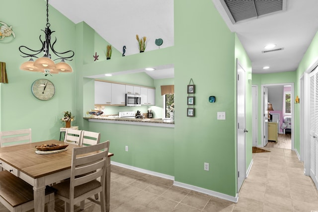 400 Melrose Pl Unit 14E, Myrtle Beach, SC 29572 - dining space featuring baseboards, light tile patterned floors, a chandelier, recessed lighting, and a towering ceiling