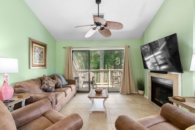 400 Melrose Pl Unit 14E, Myrtle Beach, SC 29572 - living area featuring vaulted ceiling, ceiling fan, a tile fireplace, light tile patterned floors, and a textured ceiling