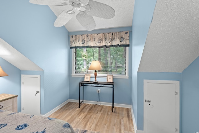 400 Melrose Pl Unit 14E, Myrtle Beach, SC 29572 - bedroom featuring wood finished floors, a textured ceiling, baseboards, and a ceiling fan