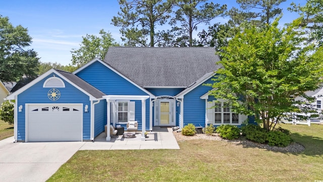 view of front of property featuring a garage, driveway, and a front yard