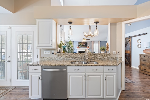 kitchen featuring dishwasher, a sink, dark wood-type flooring, white cabinets, and light stone countertops