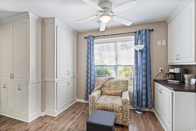 living area with ceiling fan, wood finished floors, and baseboards