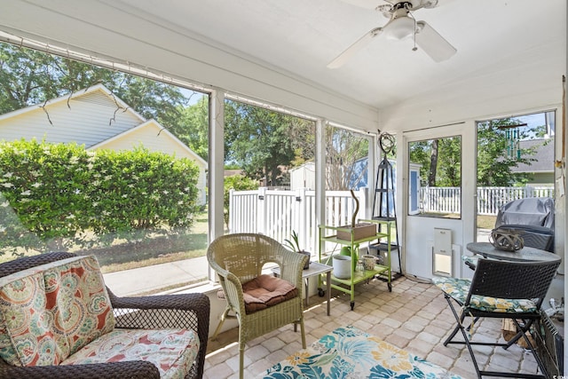 sunroom featuring a ceiling fan and lofted ceiling