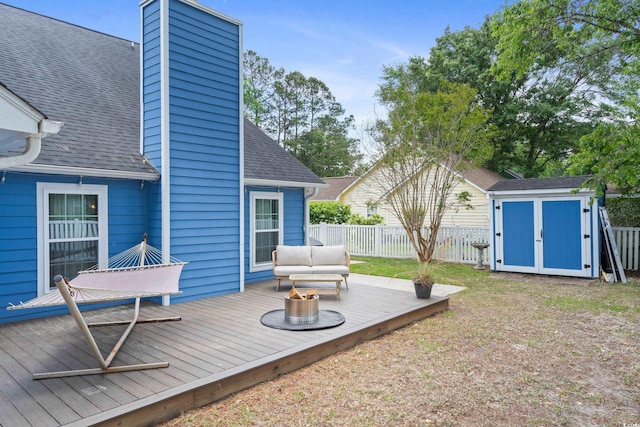 wooden deck with a shed, an outbuilding, and an outdoor hangout area