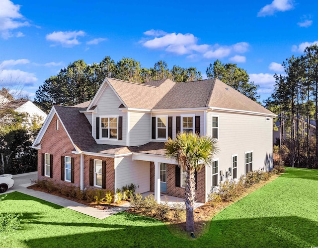 1303 Bermuda Grass Dr, Myrtle Beach, SC 29579 - traditional home with a front lawn, brick siding, roof with shingles, and a patio area
