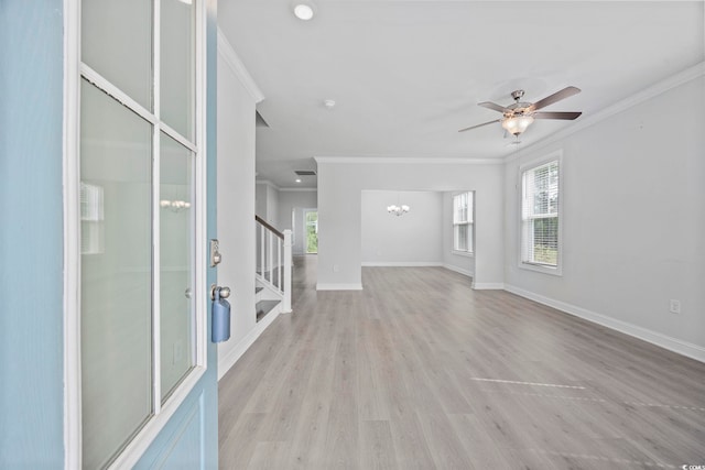 1303 Bermuda Grass Dr, Myrtle Beach, SC 29579 - unfurnished living room featuring a chandelier, ornamental molding, healthy amount of natural light, stairs, and light wood-type flooring