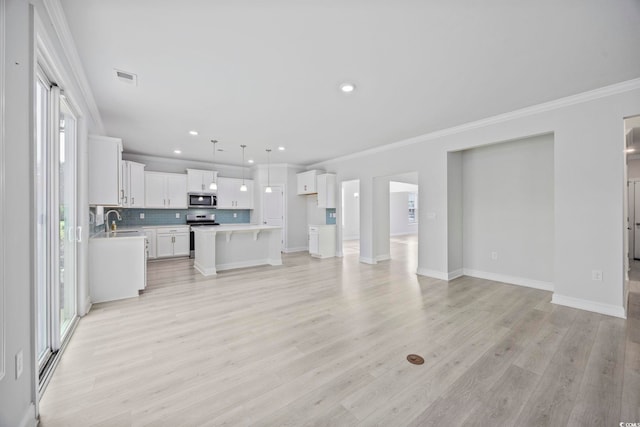1303 Bermuda Grass Dr, Myrtle Beach, SC 29579 - unfurnished living room featuring ornamental molding, light wood-type flooring, a sink, recessed lighting, and baseboards