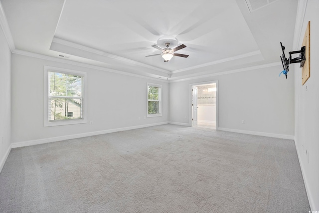 1303 Bermuda Grass Dr, Myrtle Beach, SC 29579 - empty room featuring a tray ceiling, ornamental molding, a ceiling fan, and light carpet