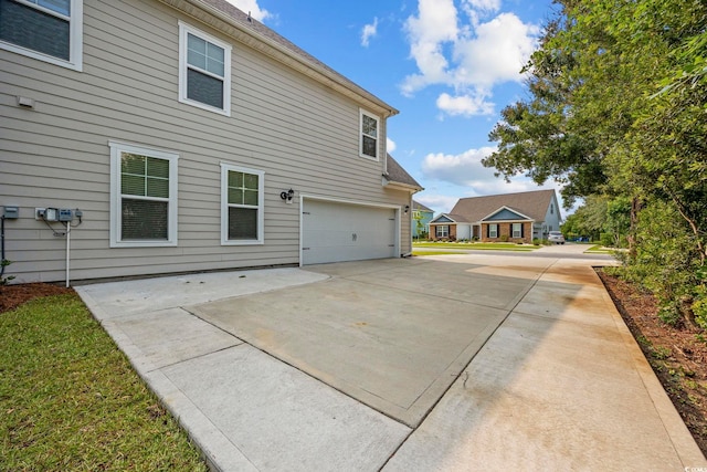 1303 Bermuda Grass Dr, Myrtle Beach, SC 29579 - rear view of house featuring a garage and concrete driveway