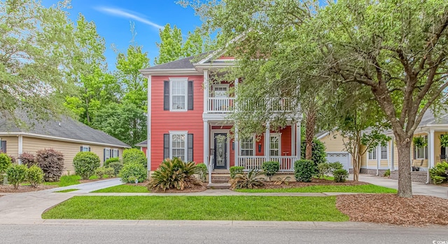 212 Greenwich Dr, Conway, SC 29526 - view of front facade featuring covered porch, a balcony, a front lawn, and concrete driveway