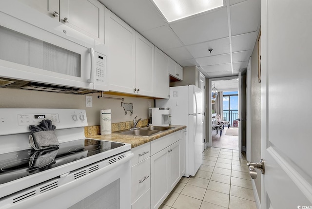 6900 N Ocean Blvd Unit 1437, Myrtle Beach, SC 29572 - kitchen with white appliances, a sink, light tile patterned floors, white cabinetry, and light countertops