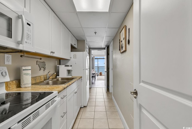 6900 N Ocean Blvd Unit 1437, Myrtle Beach, SC 29572 - kitchen with white appliances, a sink, light tile patterned floors, white cabinets, and light countertops