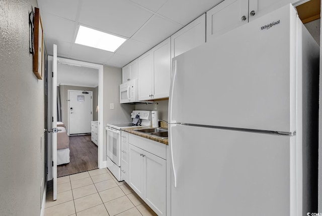 6900 N Ocean Blvd Unit 1437, Myrtle Beach, SC 29572 - kitchen featuring white appliances, white cabinetry, light tile patterned floors, and a sink